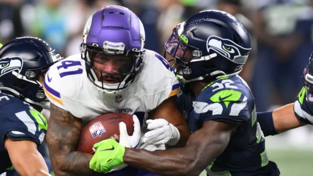 Minnesota Vikings running back Abram Smith (41) carries the ball while Seattle Seahawks safety Jerrick Reed II (32) tries to tackle during the second half at Lumen Field.